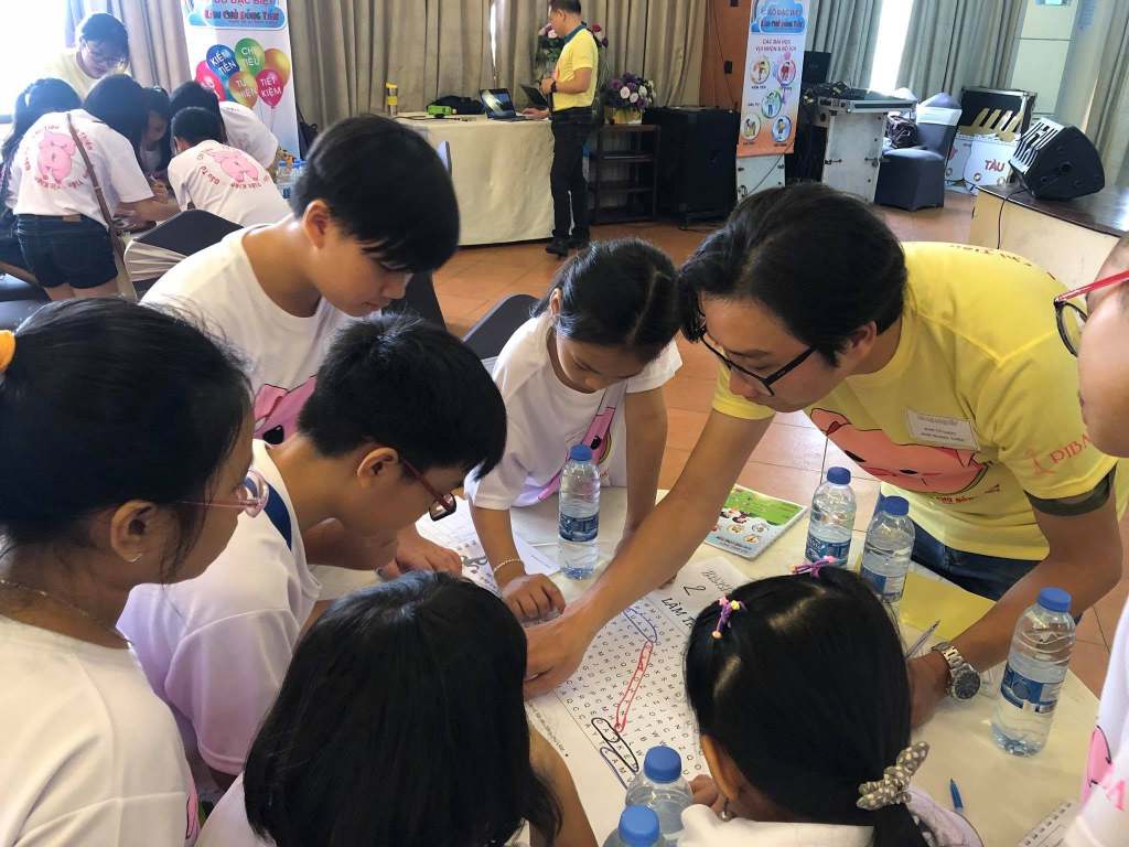 Huấn luyện viên hướng dẫn nhóm học viên làm bài tập tài chính